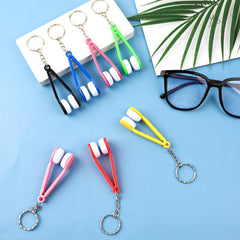 Pink tweezers-shaped glasses cleaning clip with keychain