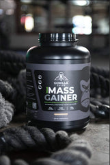 Pouring Gorilla Gulps mocha vegan mass gainer into a shaker