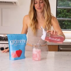 Side view of GRAMMS Clear Protein Powder Strawberry Acai