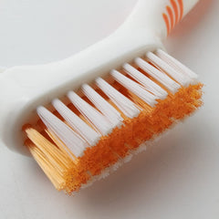 Angled brush head with multi-layered bristles for hard-to-reach areas