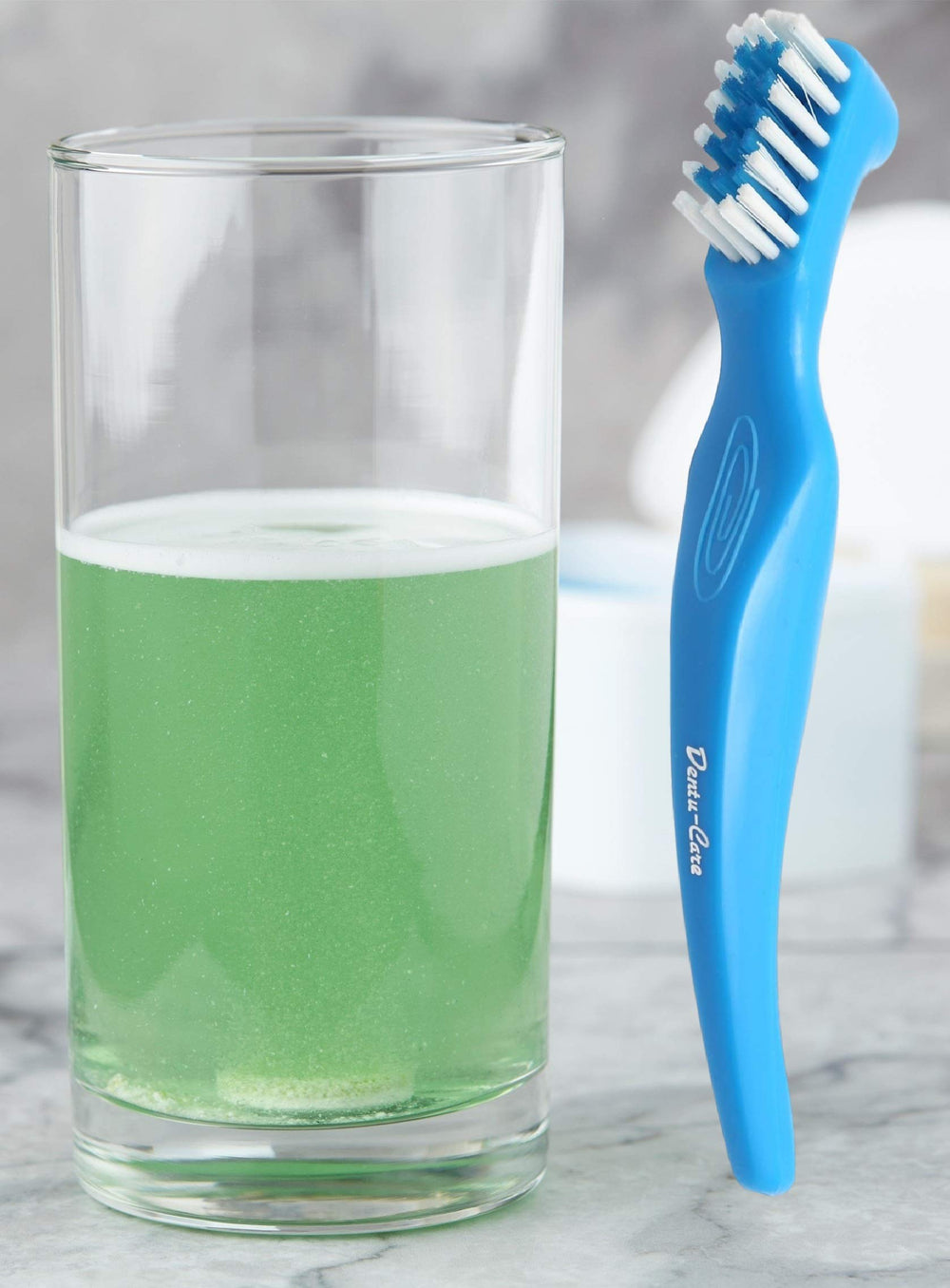 Smiling dentures with NaturDent kit in use