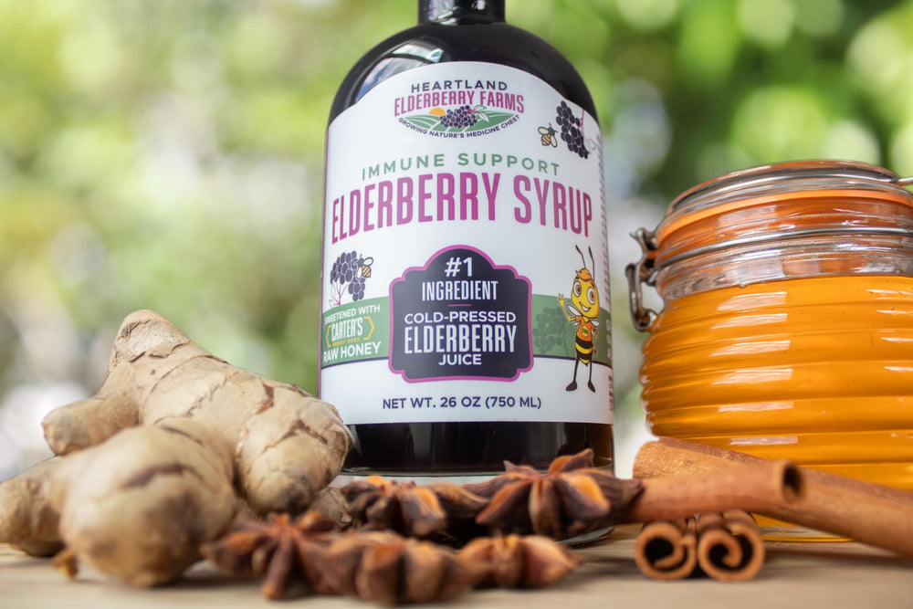 Pouring Heartland Elderberry Syrup into a cup