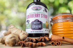 Pouring Heartland Elderberry Syrup into a cup