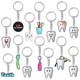 Assorted tooth-shaped keychains in 12 styles (36 pieces total)