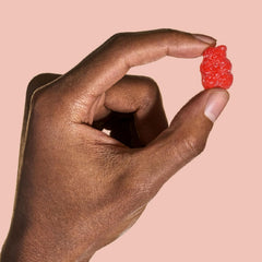 Gummies with bottle on white background