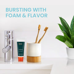 Foam from mint-flavored toothpaste on toothbrush