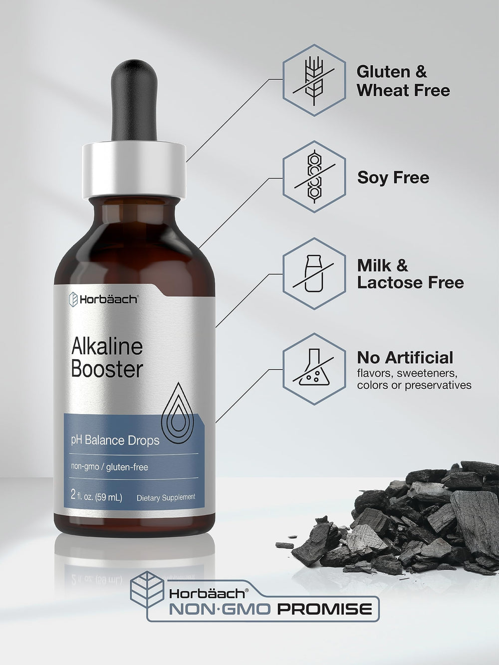 Dropper dispensing alkaline water drops into a glass