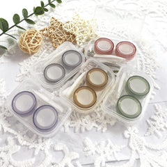 Open Howinn kit showing inserter/remover, soft-tip tweezer, lens holder, and small storage box