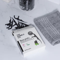 Gum health-focused floss picks in use