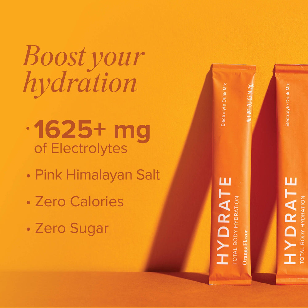 Orange Hydrate stick beside glass of water