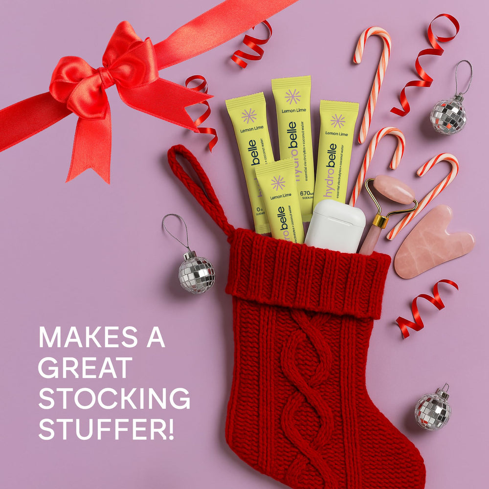 JoinBelle HydroBelle Lemon Lime powder being poured into a glass of water