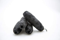 Close-up of bamboo charcoal floss texture with mint flavor