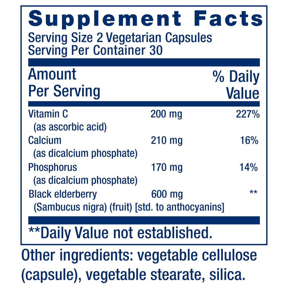 Close-up of elderberries and vitamin C tablets