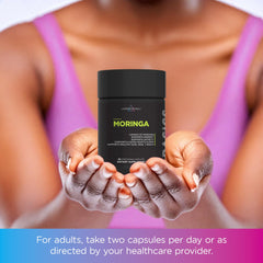 Lifestyle image with moringa capsules and greens