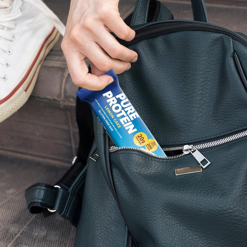 Lulurose Pure Protein Bars Lemon Cake bar being unwrapped for on-the-go energy.