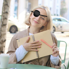 Eye patch covers one eye to block light for amblyopia treatment