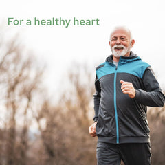 Person taking a magnesium citrate softgel with glass of water