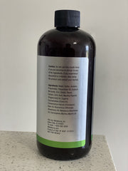 Close-up of Melaleuca Breath-Away Mouth Rinse label showing Peppermint Cinnamon Clove Rosemary and T36-C5 Oil