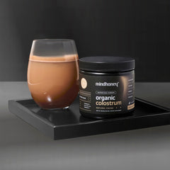 Scooper with cacao flavored colostrum powder