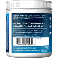 Measuring scoop of Hydration+ with a glass of water