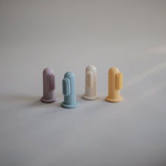 Close-up of soft silicone bristles on Mushie finger toothbrush