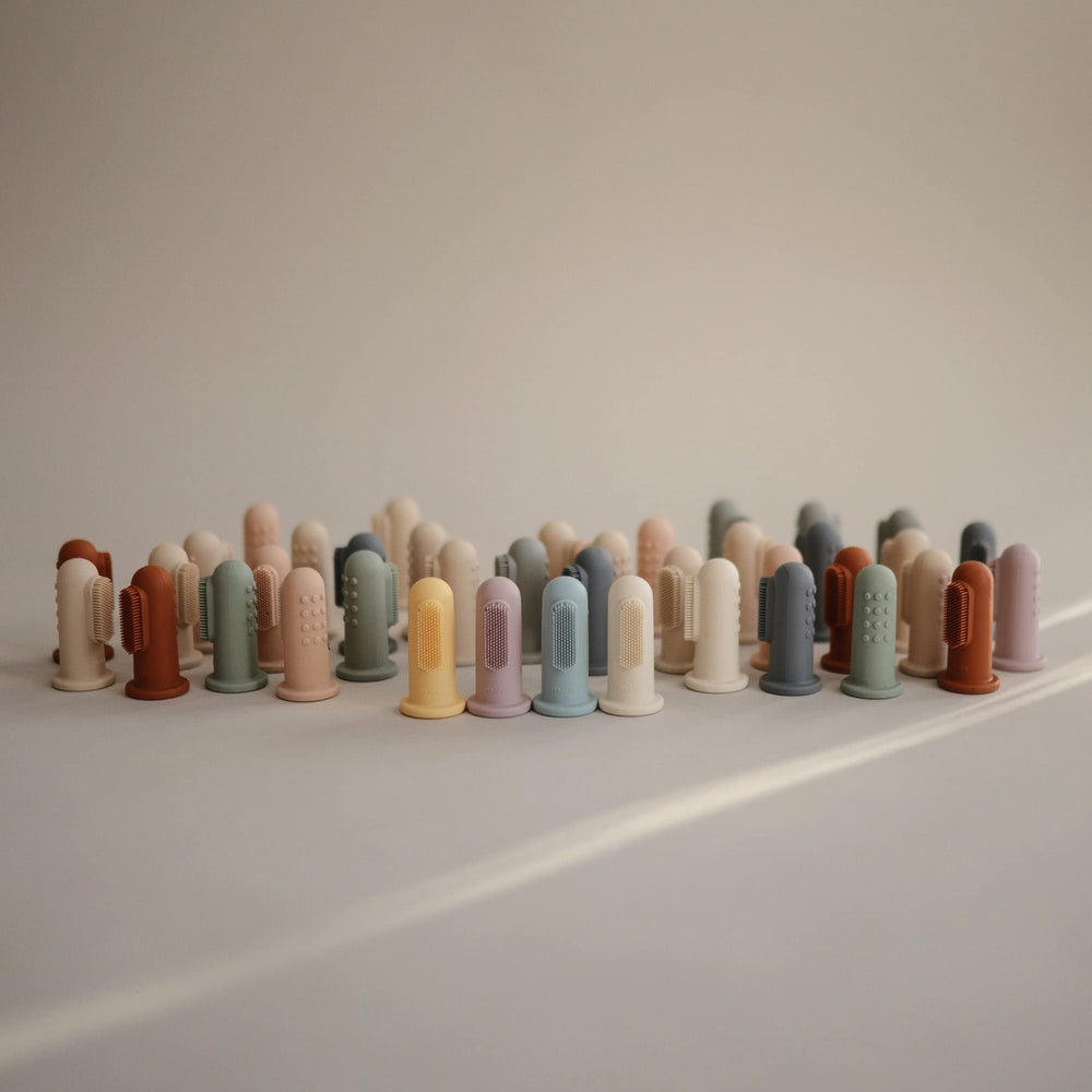 Not a toy: adult supervision required for Mushie finger toothbrush