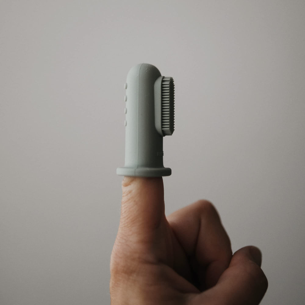 Close-up of silicone finger toothbrush on finger