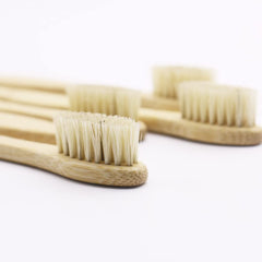 Natural bamboo toothbrush on white background