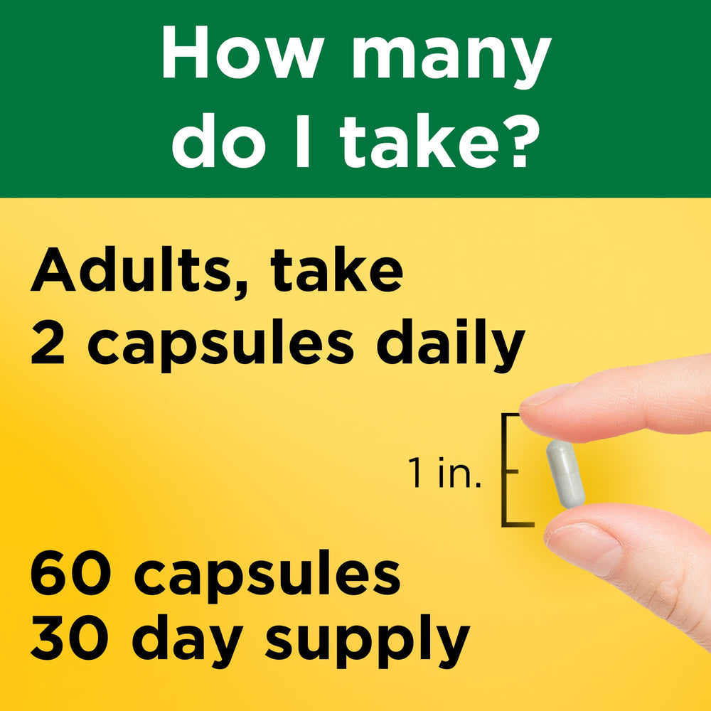 Bottle with spoon showing two-capsule daily dose of Nature Made Magnesium Glycinate.