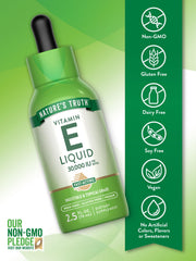 Dropper dispensing vitamin E oil into a small glass dish