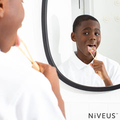 Adult and child using NIVEUS tongue scraper safely