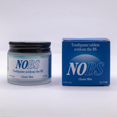 Person brushing teeth with NOBS toothpaste tablets