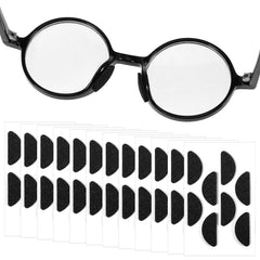 Black D-shaped foam eyeglasses nose pads on sheet