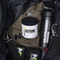 NutraBio glycine powder flat lay with container and scoop