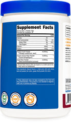 Serving scoop with powder next to bottle