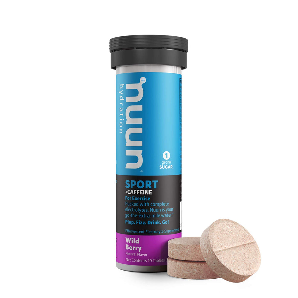 Nuun Energy Wild Berry tablet dissolving in water, releasing clean caffeine.