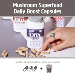Mushroom powder and capsules arranged on wooden surface