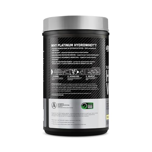 Prepared protein shake in glass with shaker nearby
