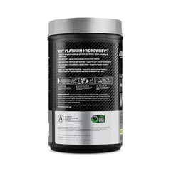 Prepared protein shake in glass with shaker nearby