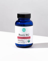 Lifestyle image of a person taking Ora Organic B12 raspberry chewable