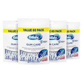 Front view of four 60-count bags of Oral-B Glide Gum Care floss picks