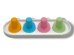 Pastel yellow Oral-B iO toothbrush head holder on a bathroom counter