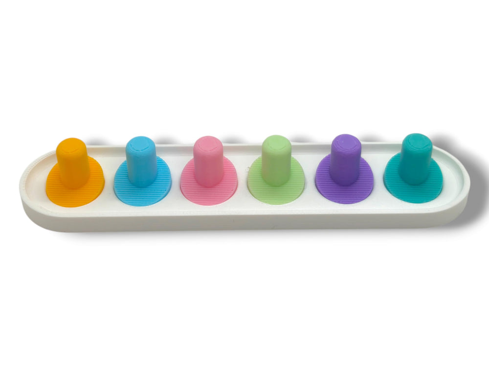 Pastel pink Oral-B iO toothbrush head holder with heads