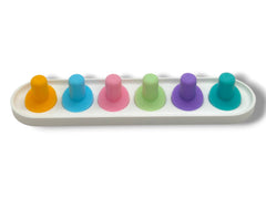 Pastel pink Oral-B iO toothbrush head holder with heads