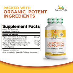 Fresh turmeric root and ginger root on a white surface