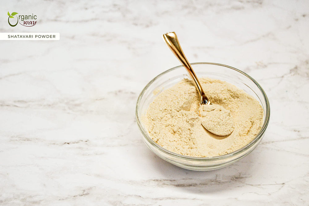 Shatavari powder in a wooden scoop with powder spread