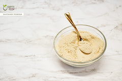 Shatavari powder in a wooden scoop with powder spread