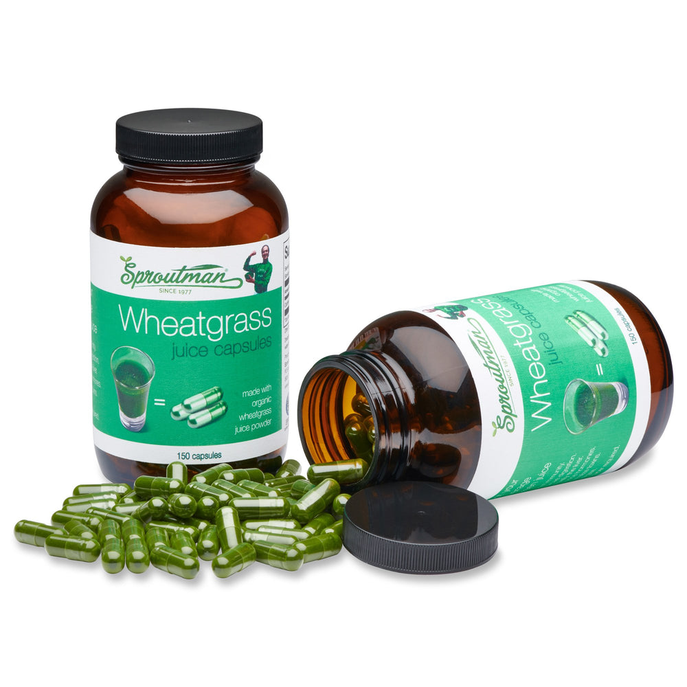 Healthy lifestyle concept with organic wheatgrass capsules and a glass of water
