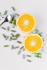 Pines Organic Wheat Grass Tablets bottle with glass of juice