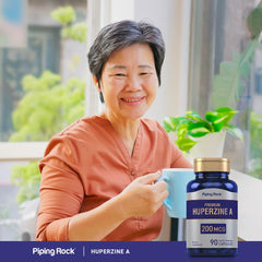 Piping Rock Huperzine A glass bottle on a desk for daily supplement routine.
